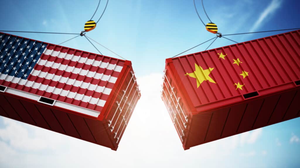 US trade. Trade war concept with American and Chinese flag textured cargo containers clashing.